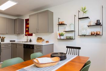 A kitchen with a table set for two.